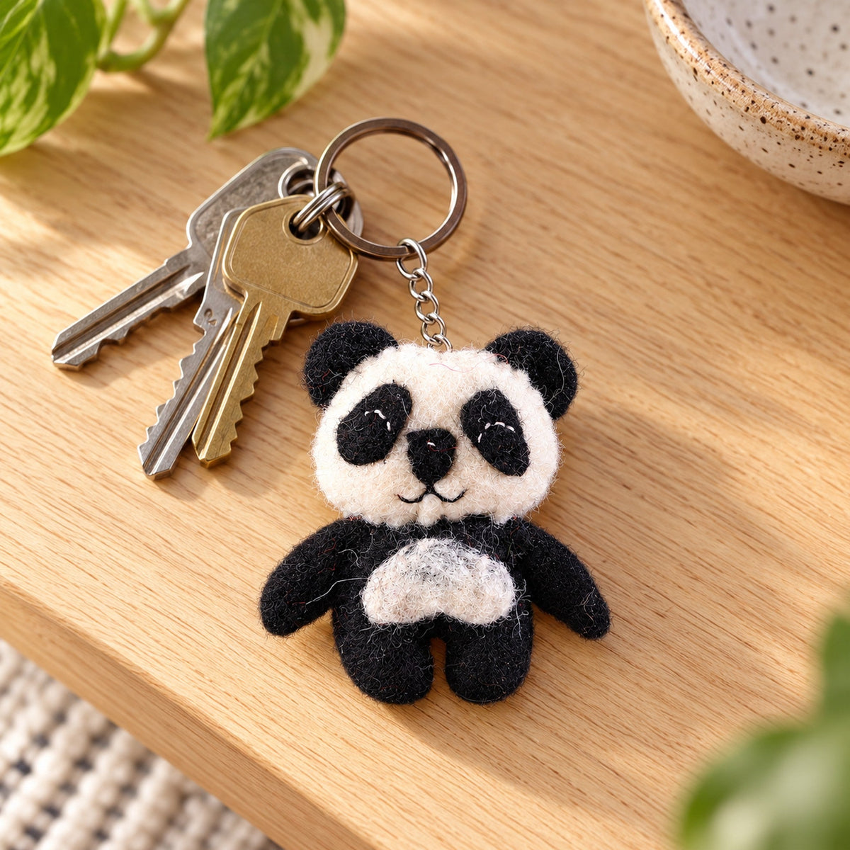 Bamboo the Panda, a black-and-white felt panda keychain, beside a named gift tag and a handwritten household gift list.