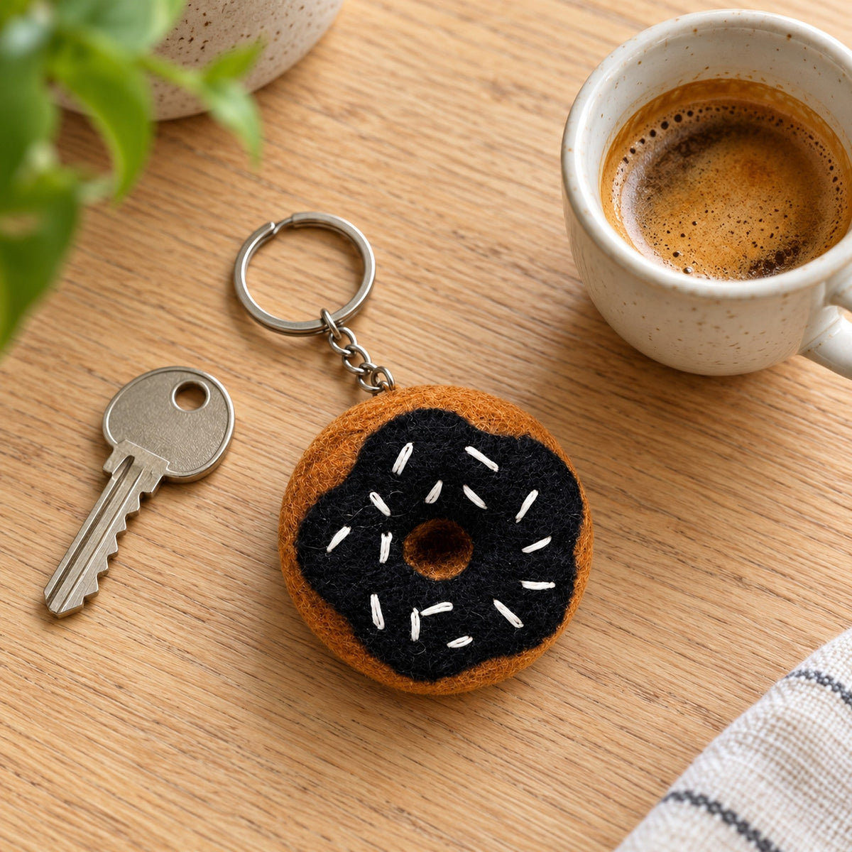 Choco Donut felt keychain with dark chocolate icing and little white sprinkles.