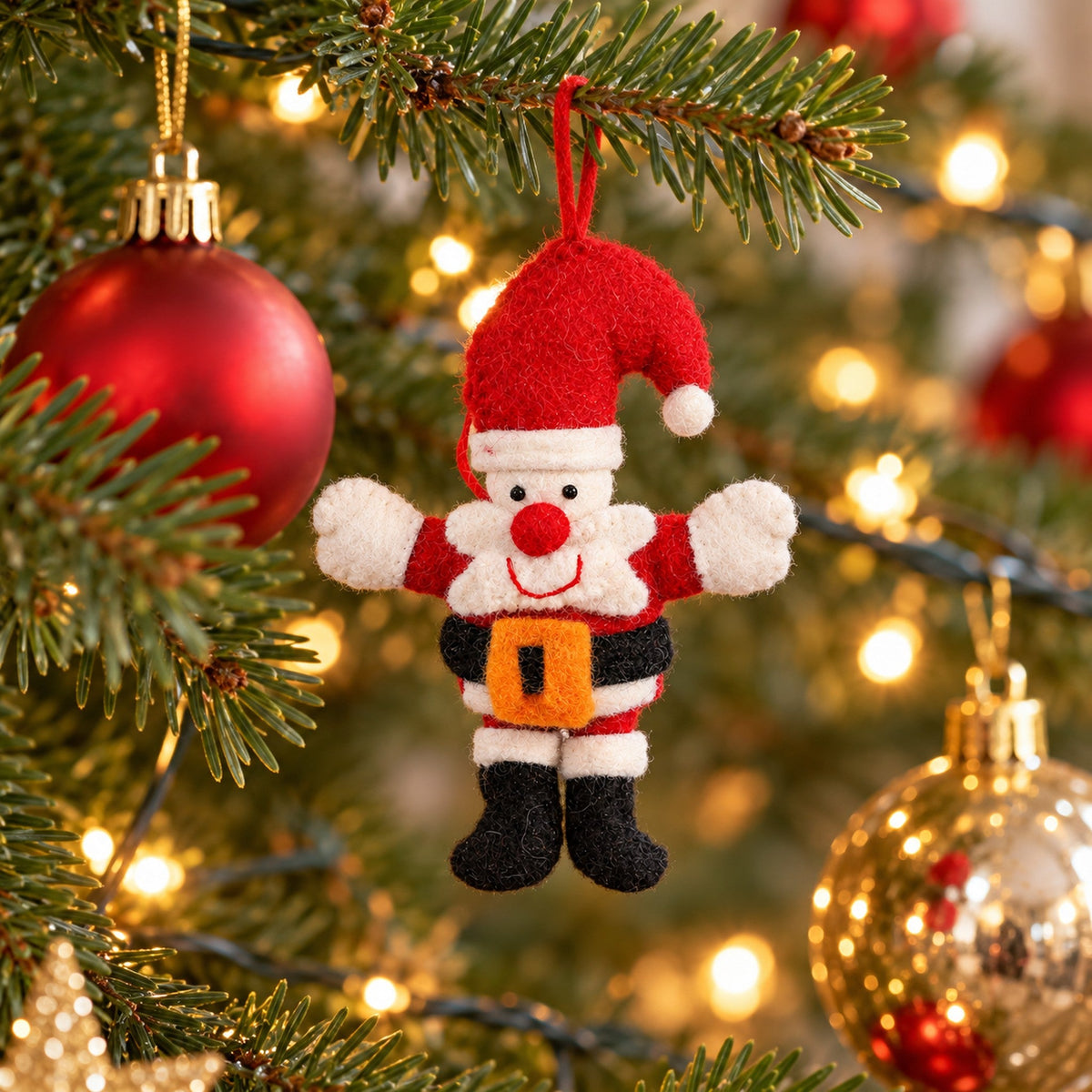 Big Hug Santa felt ornament with a tall red hat and open arms rests in a storage compartment with its hanging loop laid separately above it.